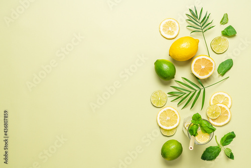 Summer pastel green citrus background. Slices of lemon, lime and mint. Top view, copy space