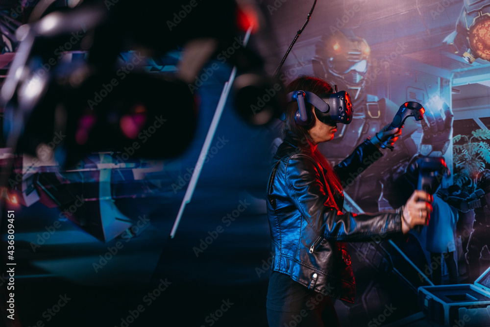 Obraz premium Virtual reality. A woman plays games in a virtual reality helmet.