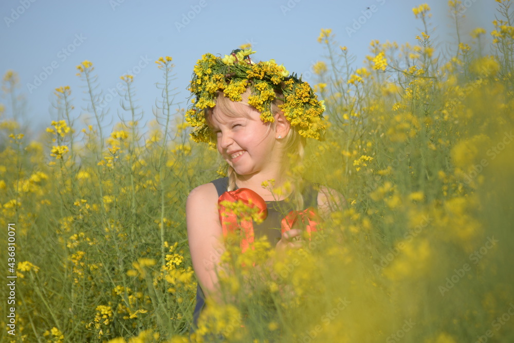 Little blonde girl is playing in a meadow flower Little blonde girl is playing in a meadow flower