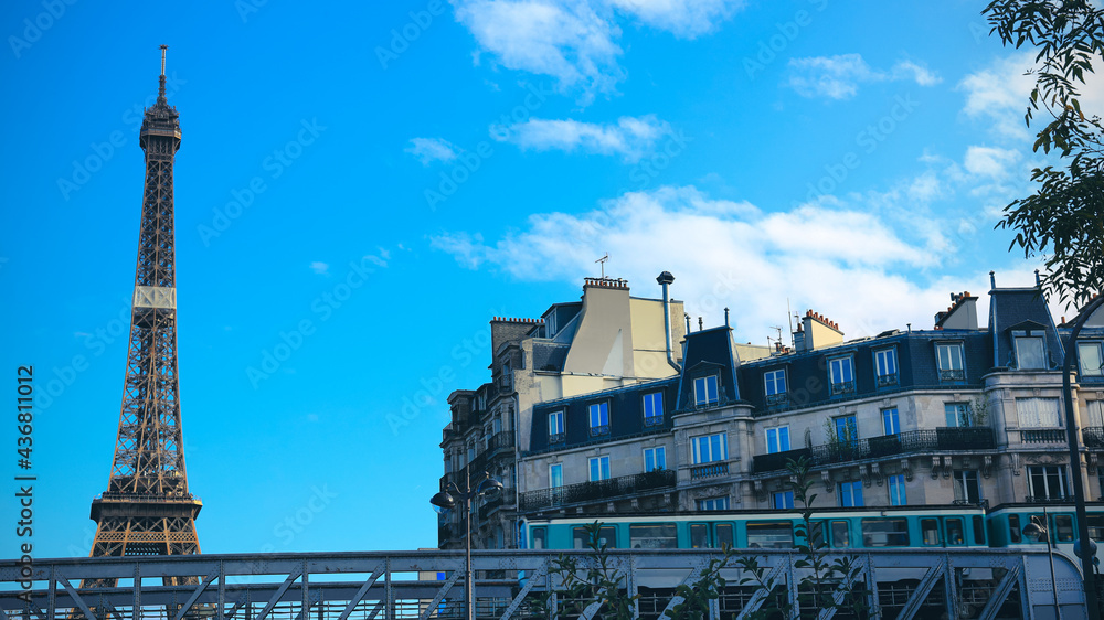 Fototapeta premium Beautiful view of Eiffel tower with the subway train and blue sky background