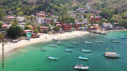 Aerial view of boats and colourful houses of coasline in Yelapa town  in Cabo Corrientes, Jalisco, Mexico. Bay Bahía de Banderas. Yachts, beach, blue ocean. Vacation in paradise .  sea and sky. photo