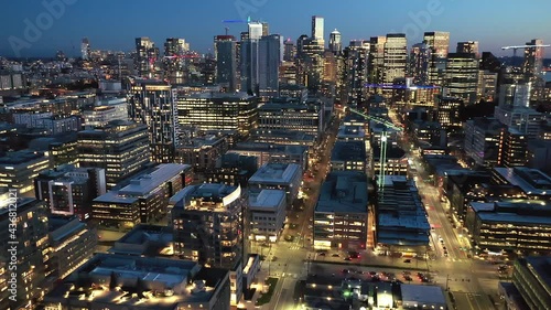 Cinematic 4K drone, after sunset, night dolly clip of downtown Seattle with illuminated streets and offices looking from South Lake Union in Seattle, Washington during blue hour