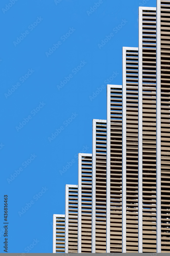 Fototapeta premium Geometric architecture detail against blue sky