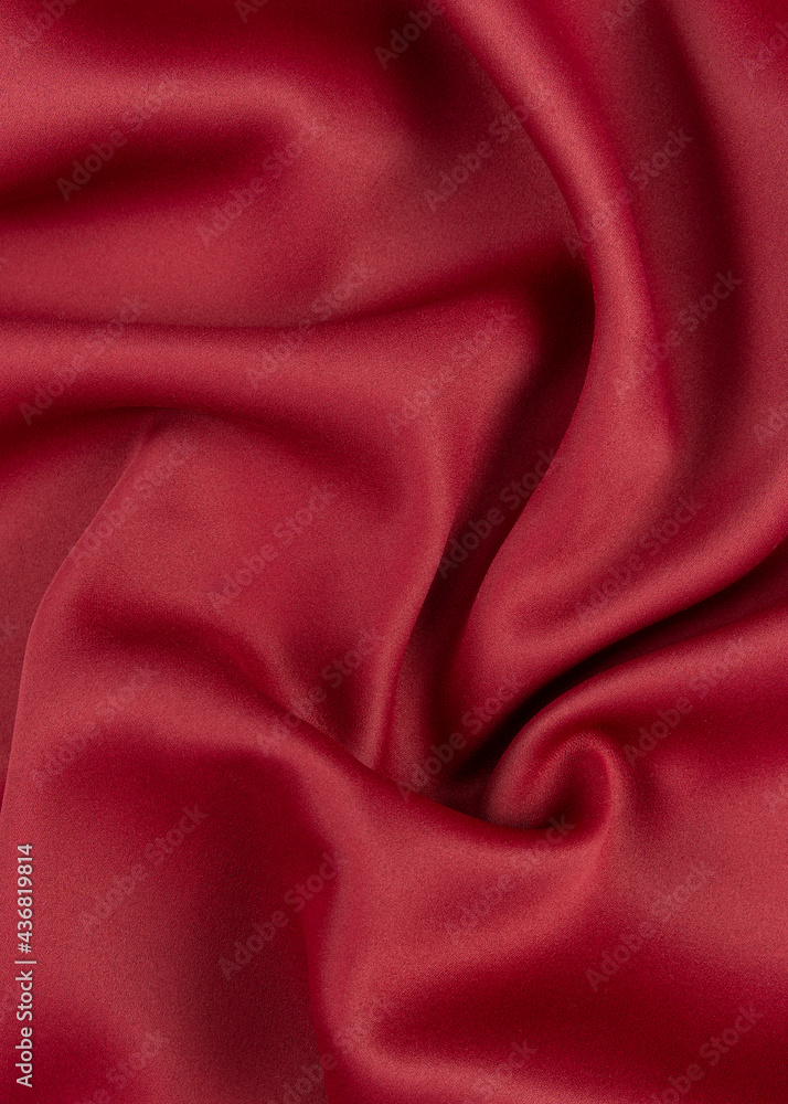 Obraz premium a fragment of a red curtain in folds.