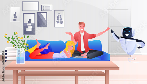 couple on couch controlling home robot artificial intelligence technology concept