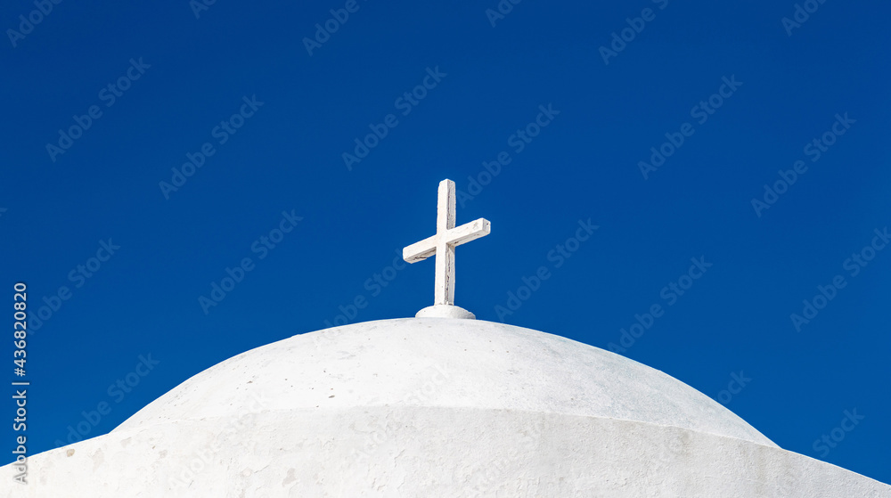 White orthodox greek church with cross on clear blue sky background. Summer vacation destination. White orthodox greek church with cross on clear blue sky background. Summer vacation destination.