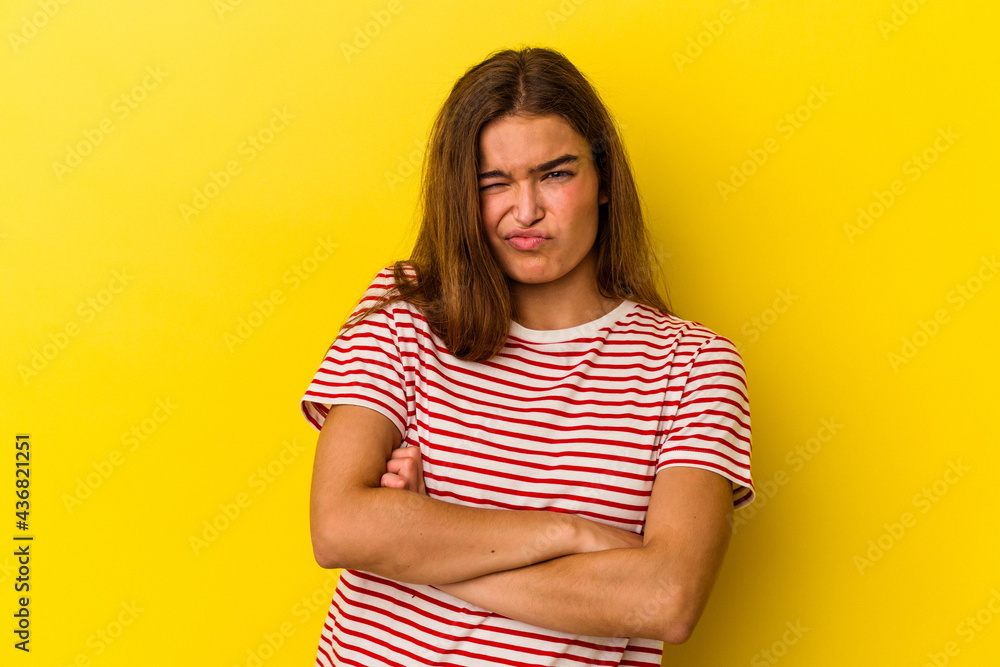 Young caucasian woman isolated on yellow background unhappy looking in camera with sarcastic expression. Young caucasian woman isolated on yellow background unhappy looking in camera with sarcastic expression.