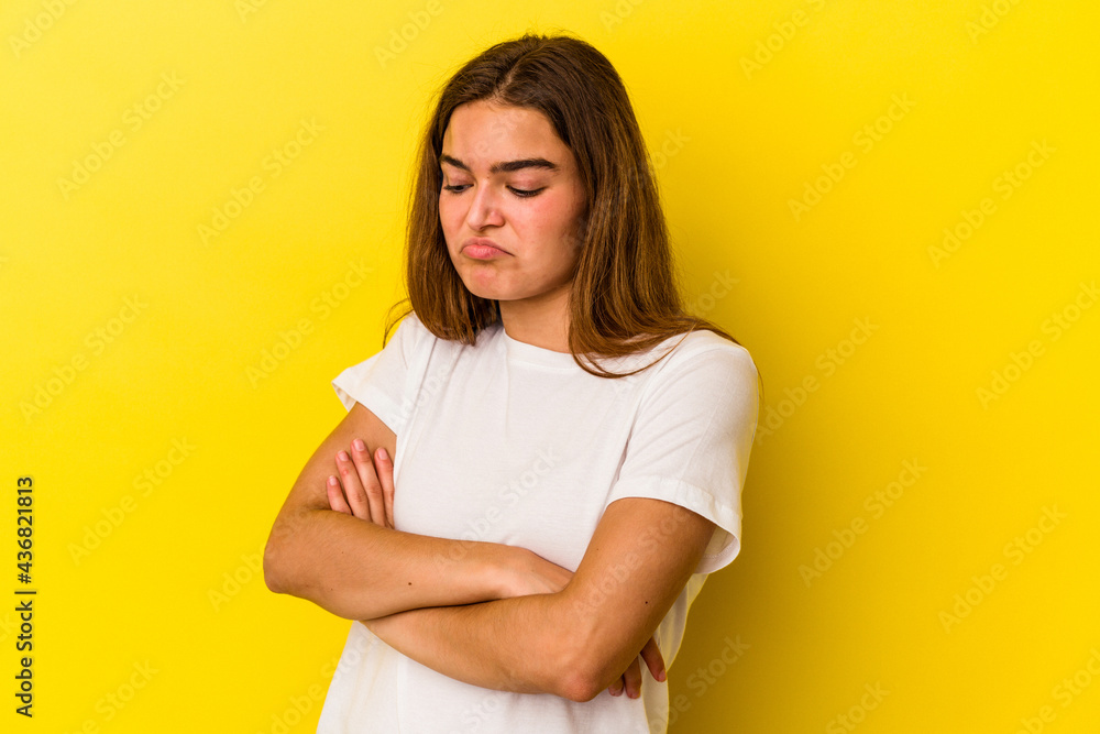Young caucasian woman isolated on yellow background tired of a repetitive task. Young caucasian woman isolated on yellow background tired of a repetitive task.