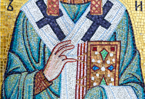 Christian Orthodox Greek icon with saints in the form of ceramic mosaics on the facade of the Orthodox church. Traditional christian greek decor and fresco. 