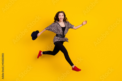 Fototapeta Naklejka Na Ścianę i Meble -  Full body profile side photo of amazed happy young woman jump run empty space isolated on yellow color background