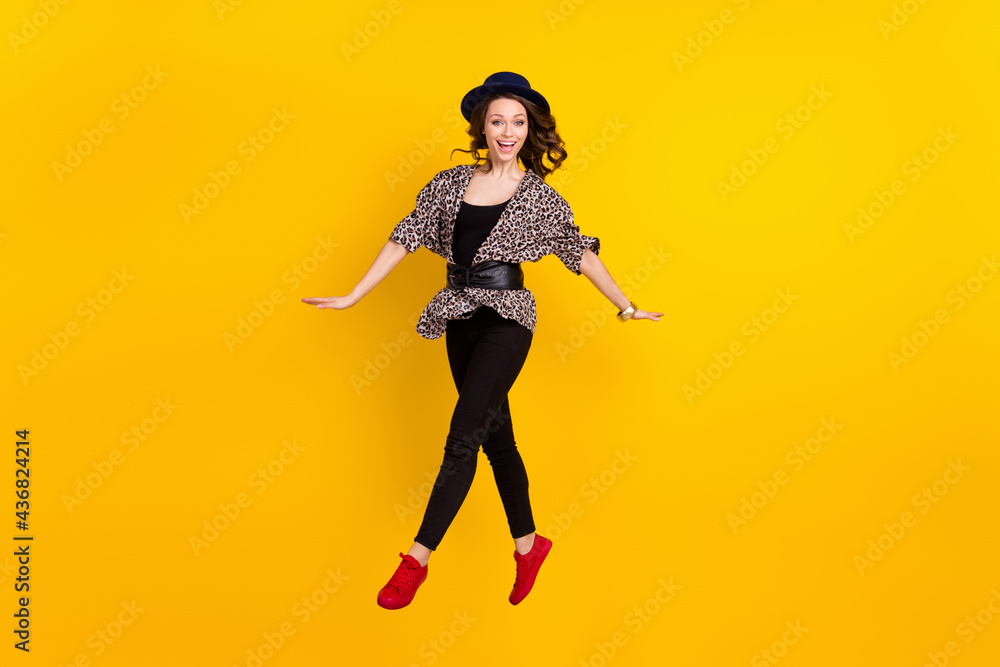 Full body photo of attractive young happy lady jump up smile good mood isolated on yellow color background Full body photo of attractive young happy lady jump up smile good mood isolated on yellow color background