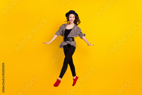 Full body photo of attractive young happy lady jump up smile good mood isolated on yellow color background