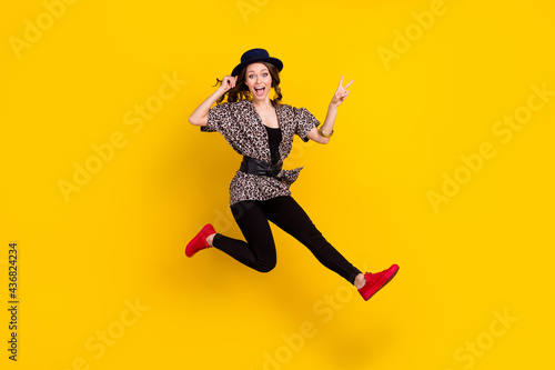 Full body photo of crazy excited young woman jump up show v-sing isolated on yellow color background