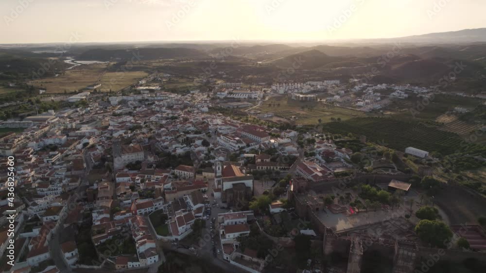 Castle and fortified walled medieval city of Silves, Algarve at sunset. Aerial view Castle and fortified walled medieval city of Silves, Algarve at sunset. Aerial view