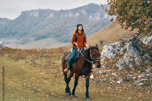 woman hiker riding horse mountains landscape travel adventure
