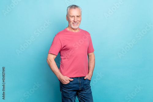 Photo portrait of bearded man pink t-shirt jeans smiling confident isolated pastel blue color background