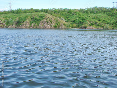Amazing landscape of the water surface of the Dnieper covered with ripples from a small wind  and illuminated by sunlight.