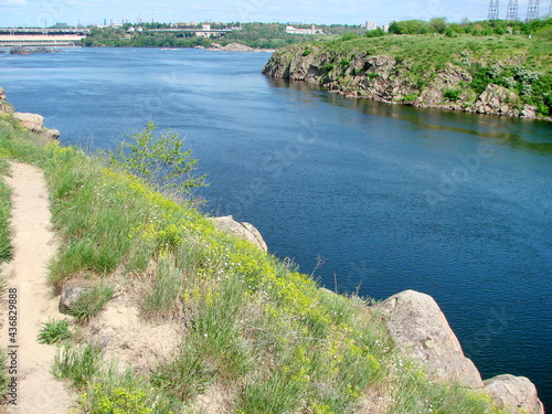 Panorama from above of the azure water surface of the old Dnieper riverbed that washes the rocky shores of the island of Khortytsia.