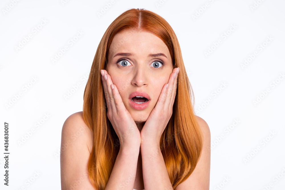 Photo of impressed sad ginger hairdo lady hands cheeks isolated on bright color background Photo of impressed sad ginger hairdo lady hands cheeks isolated on bright color background