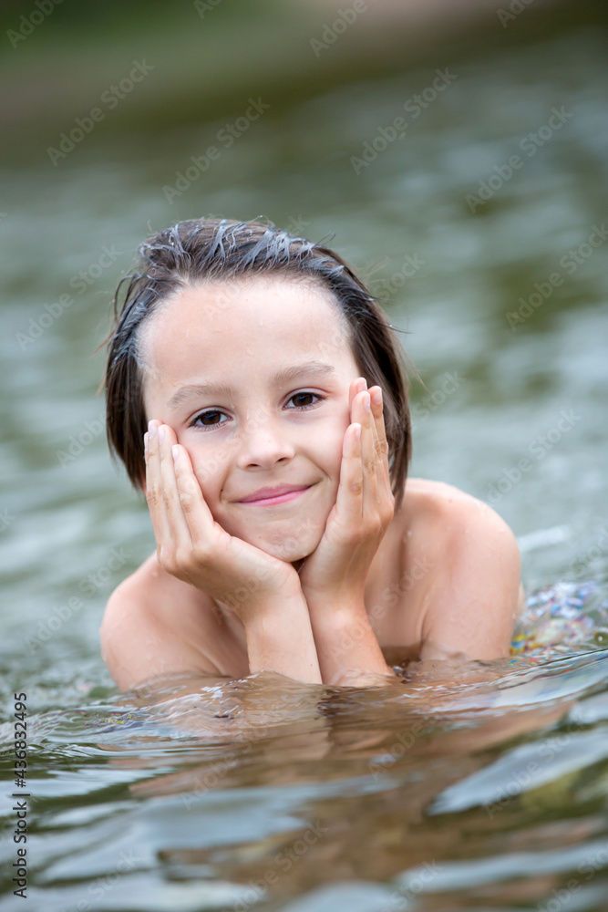 Beautiful portrait of child in lake, kid playing Beautiful portrait of child in lake, kid playing