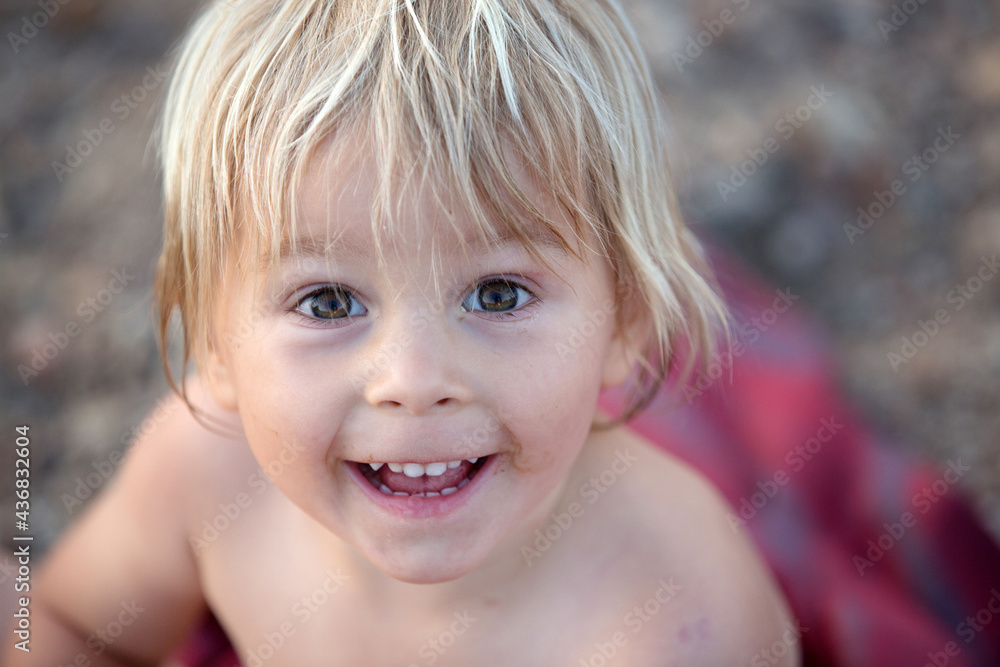 Children, playing in a lake on sunset, swimming and running, splashing water, summertime Children, playing in a lake on sunset, swimming and running, splashing water, summertime