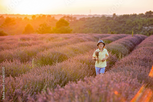 Cute little child, beautiful boy, playing in lavender field