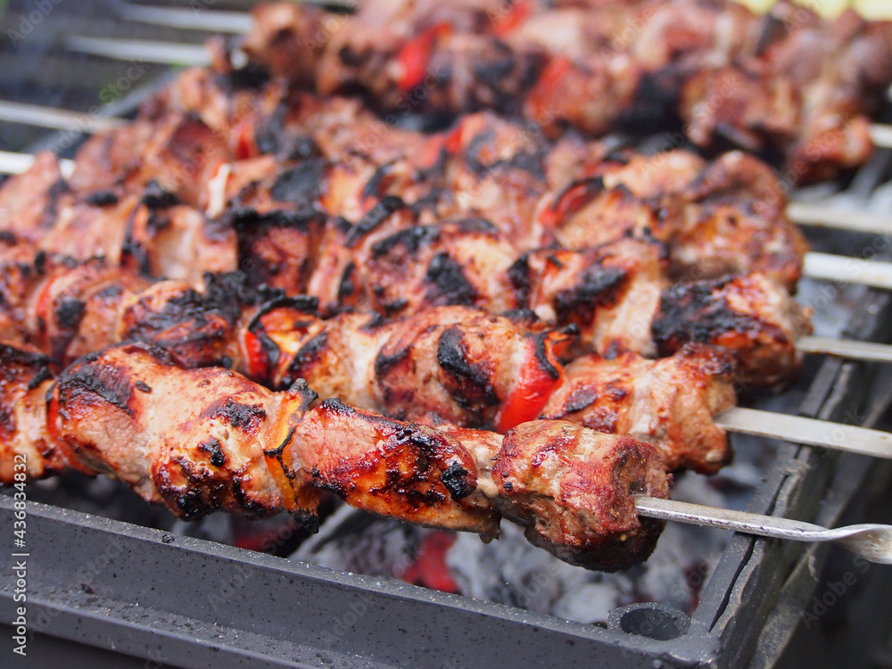 Shashlik on skewers is prepared on the grill over the coals.  Marinated meat is cooked on coals.
