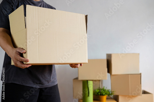 House moving concept. Man holding cardboard box, closeup. © jittawit.21