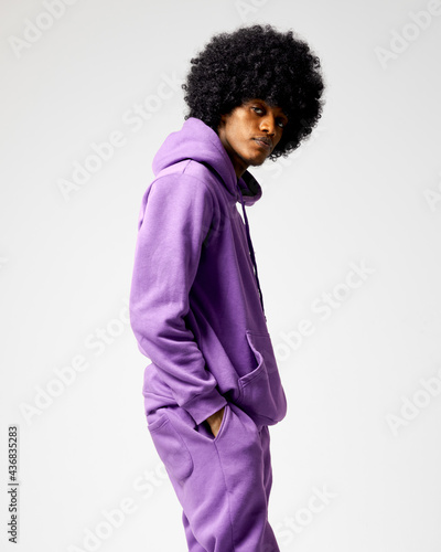 Young black man in set of purple tracksuit photo