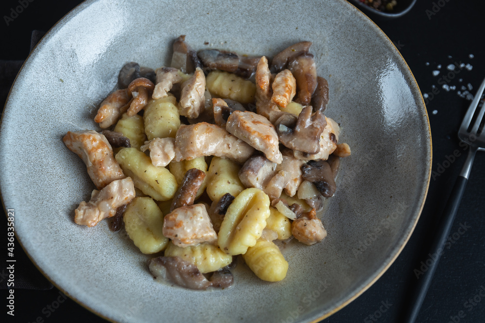 Potato gnocchi with chicken on plate Potato gnocchi with chicken on plate