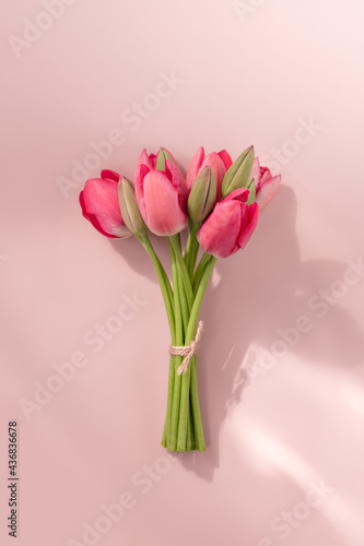 Bouquet of pink tulips on pink background. Vertical orientation. © Екатерина Алдошина