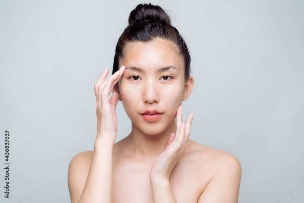 Beautiful young asian woman with clean fresh skin on white background. Asian women portrait. Beautiful young asian woman with clean fresh skin on white background. Asian women portrait.