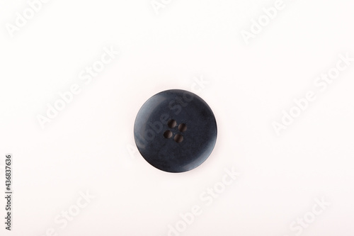 Top view of an old black plastic button.
