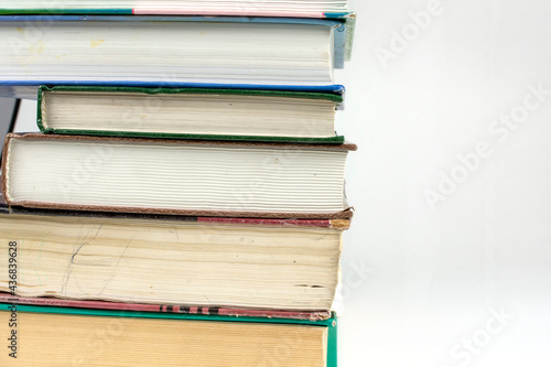 stack of thick books on white background