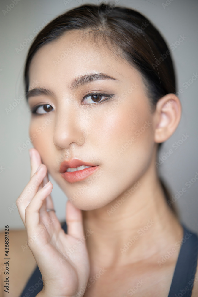 Beautiful young asian woman with clean fresh skin on white background. Asian women portrait. Beautiful young asian woman with clean fresh skin on white background. Asian women portrait.