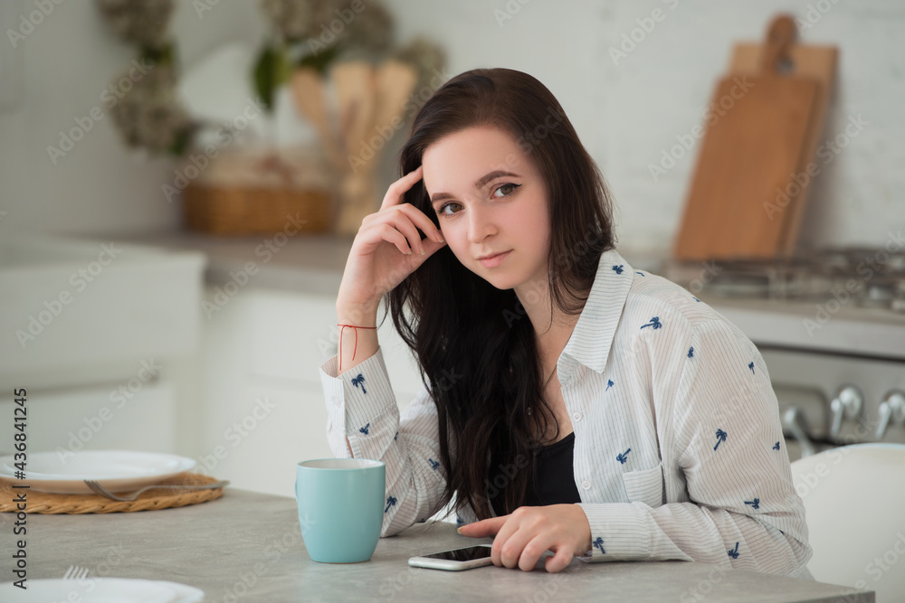 Young brunette woman student with mobile phone. Social networks, smartphones and modern gadgets as a means of communication and leisure activities. Young brunette woman student with mobile phone. Social networks, smartphones and modern gadgets as a means of communication and leisure activities.