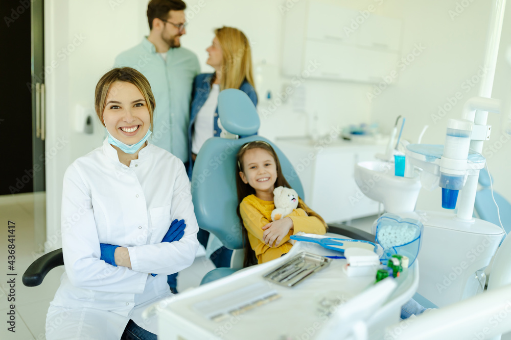 Portraits of cute little girl sitting in dental chair and smiling young kind female dentist. Portraits of cute little girl sitting in dental chair and smiling young kind female dentist.