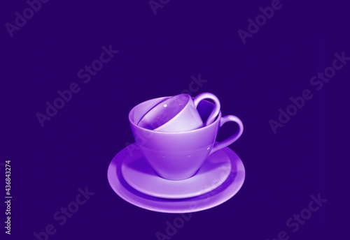 Pop art style purple colored stack of two different size of coffee cup sets on deep violet background