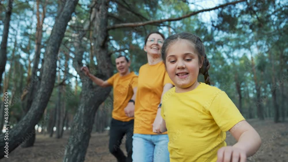Happy family in park. Daughter and her parents are run in park. Hiking with family. Happy family have fun trip. Forest park. Daughter and her parents are running through park. Happy family in forest Happy family in park. Daughter and her parents are run in park. Hiking with family. Happy family have fun trip. Forest park. Daughter and her parents are running through park. Happy family in forest