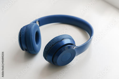 Blue headphones on white background close up