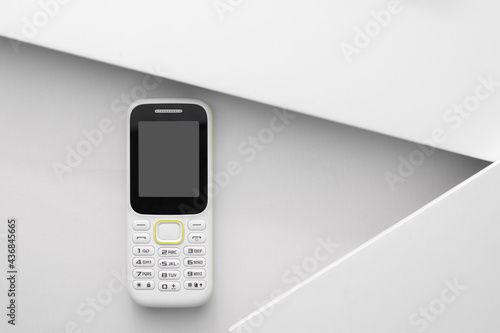 White handphone on white board, White table