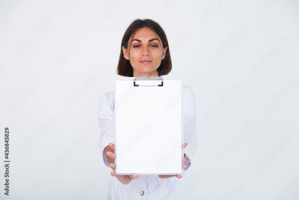Female doctor in lab coat on white background isolated, confident smile hold white paper blank with empty space Female doctor in lab coat on white background isolated, confident smile hold white paper blank with empty space