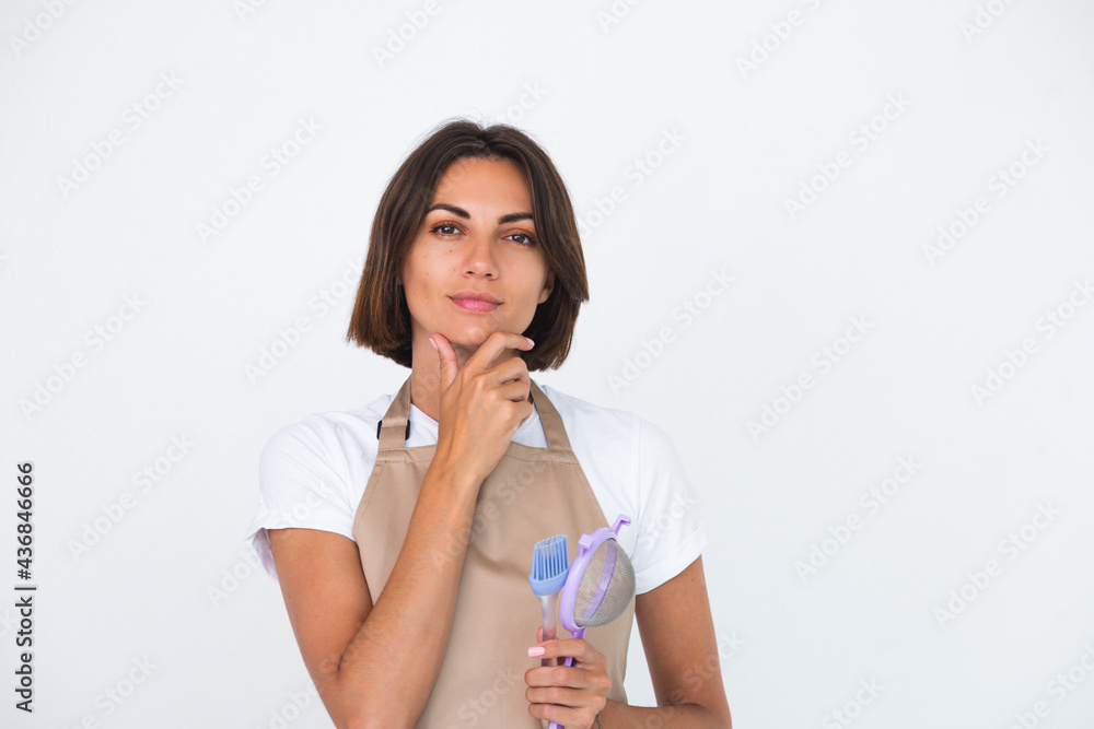 Happy housewife in apron isolated on white background thoughtful think about recipe what to make Happy housewife in apron isolated on white background thoughtful think about recipe what to make