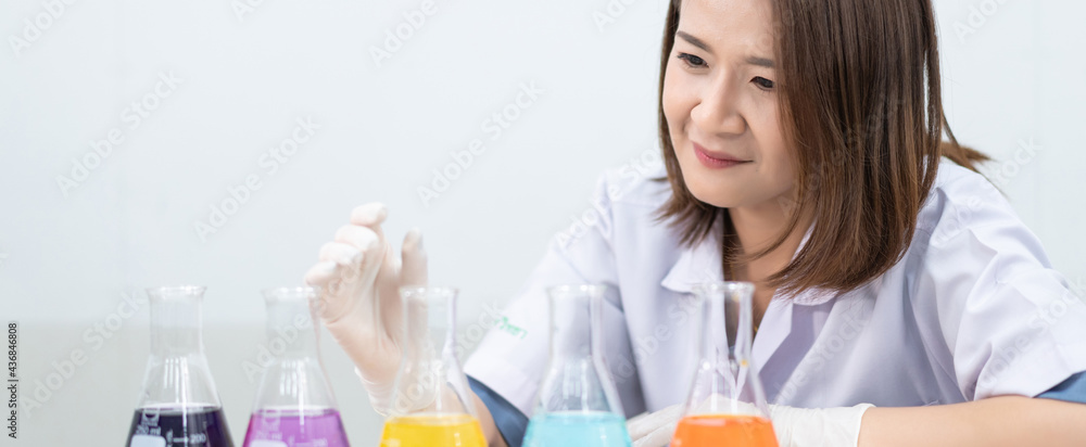 A young woman researcher, doctor, scientist, or laboratory assistant working with plastic medical tubes to research, examine scientific experiments in a modern laboratory. Education stock photo A young woman researcher, doctor, scientist, or laboratory assistant working with plastic medical tubes to research, examine scientific experiments in a modern laboratory. Education stock photo