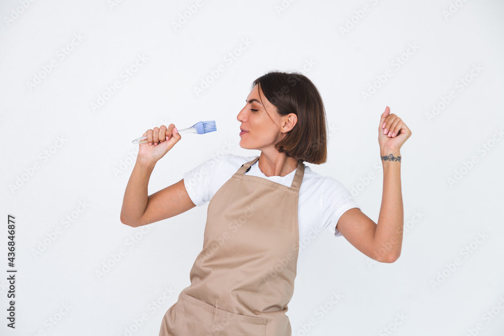 Happy housewife in apron isolated on white background Happy housewife in apron isolated on white background