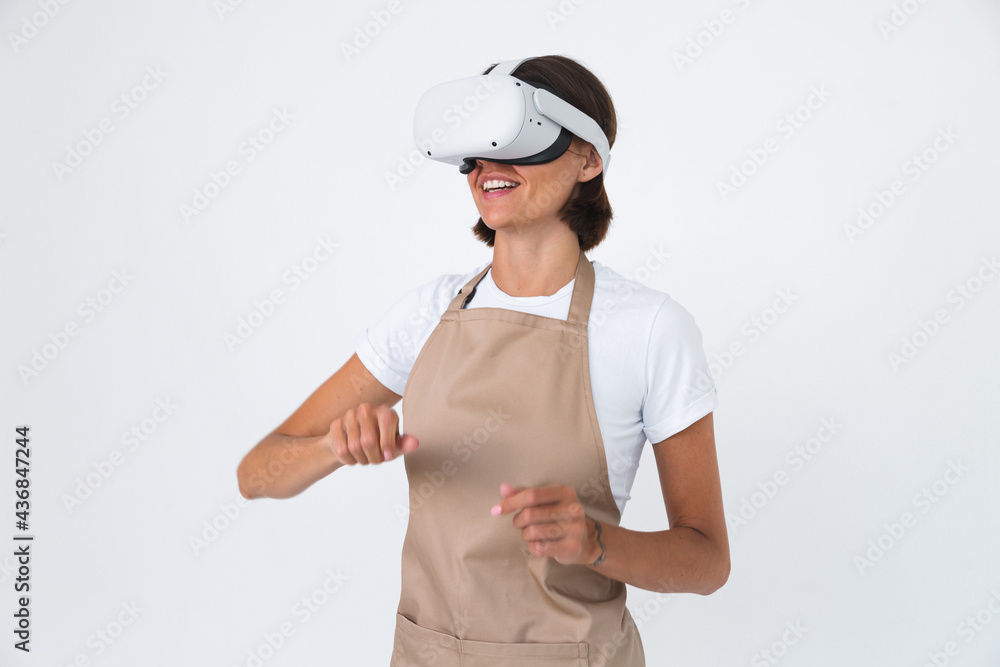 Housewife in apron isolated on white background in vr glasses cooking making dinner play games Housewife in apron isolated on white background in vr glasses cooking making dinner play games