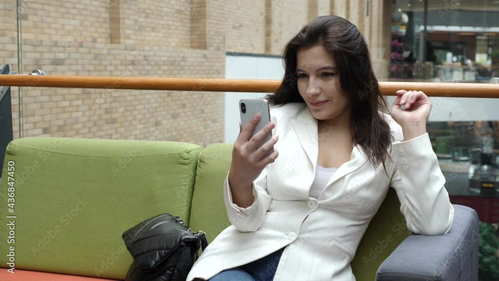 Beautiful girl tells an interesting adventure on a smartphone camera. Beautiful girl tells an interesting adventure on a smartphone camera.