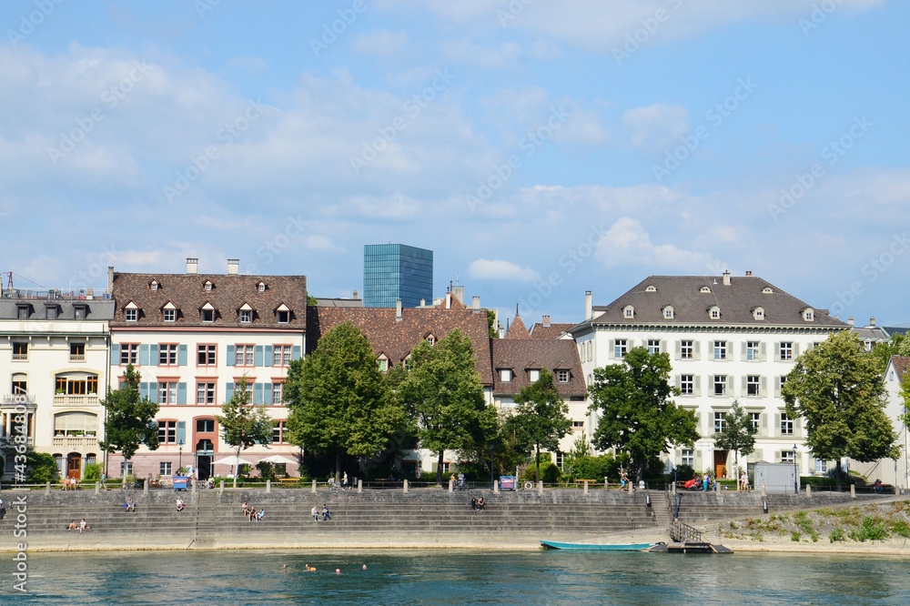 Local people hanging out on the bank of Rhine river and swimming in Basel, Switzerland