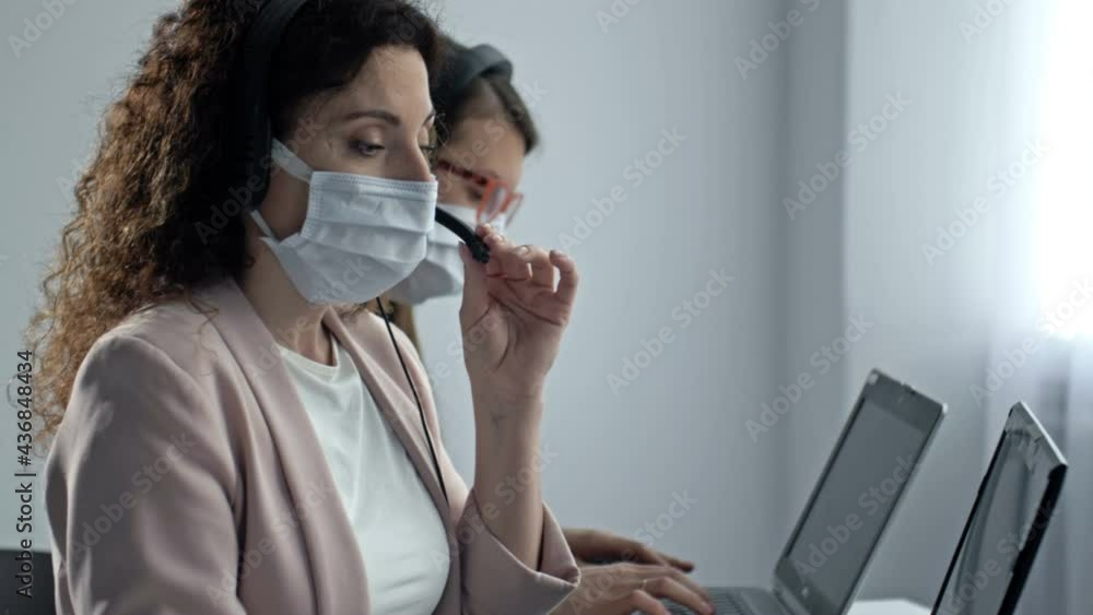 Call center operators in medical masks. Office work during the coronavirus epidemic. Call center operators in medical masks. Office work during the coronavirus epidemic.