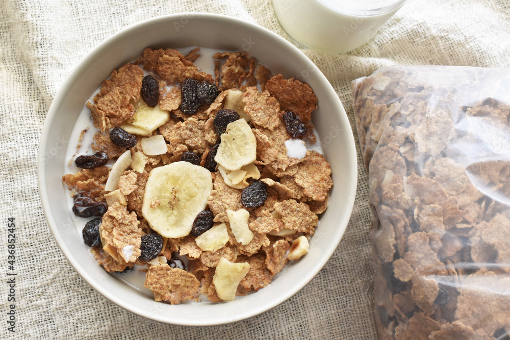 Fruit and fiber cereal with milk in a bowl. The concept of healthy breakfast, healthy food, dietary plan and weight loss program. Fruit and fiber cereal with milk in a bowl. The concept of healthy breakfast, healthy food, dietary plan and weight loss program.